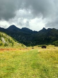 Scenic view of field and mountains against sky