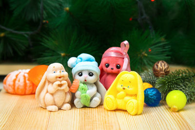 Handmade soap fragrant hares and rabbits on the background of a christmas tree and toys.