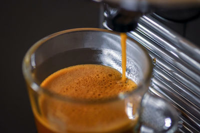 Closeup of cappuccino machine brewing fresh cup of coffee