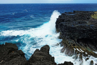 Scenic view of sea against rocks