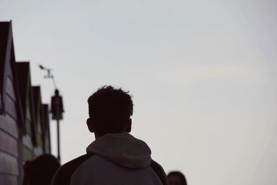 Rear view of man against clear sky