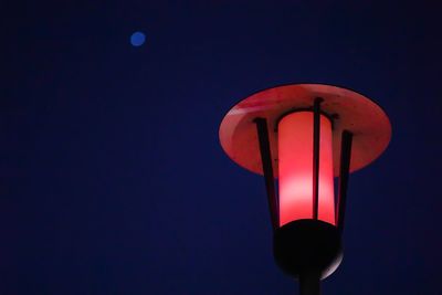 Low angle view of illuminated street light against blue sky