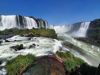 Scenic view of waterfall against sky