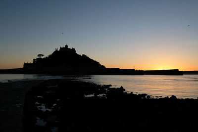 Silhouette of building at sunset