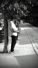 Rear view of man standing on footpath