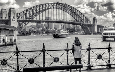 View of bridge over river against cloudy sky