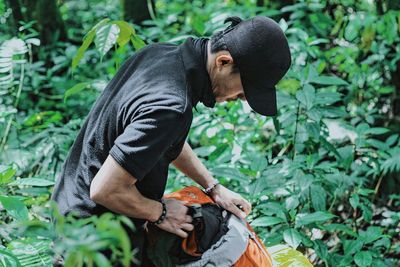 Side view of young man standing outdoors