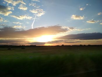 Scenic view of field against sky during sunset