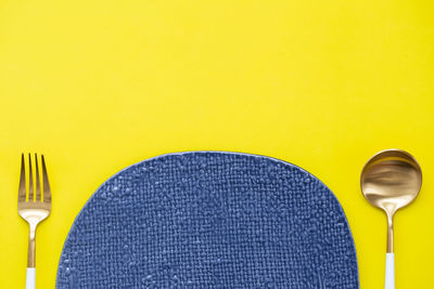 Directly above shot of drink on table against yellow background
