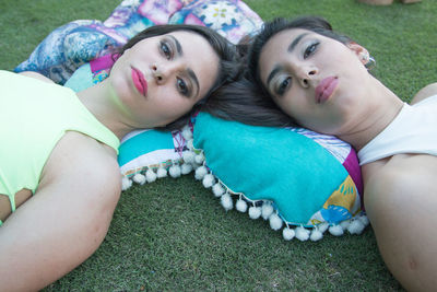 Portrait of women lying on grass