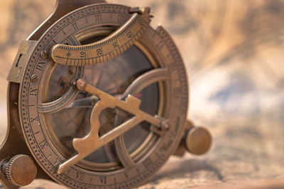 Close-up of navigational compass on map