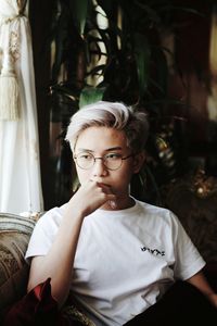 Portrait of teenage boy sitting at home