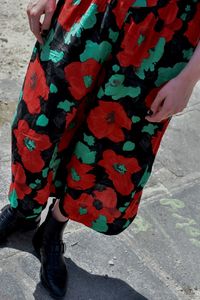 Low section of woman standing on street