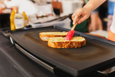 Cropped hand of person preparing food