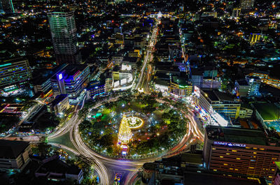 High angle view of illuminated city street and buildings at night