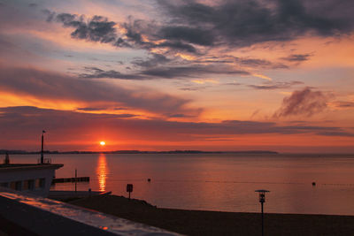 Scenic view of sea against orange sky