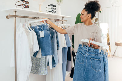 Smiling woman shopping at clothing store