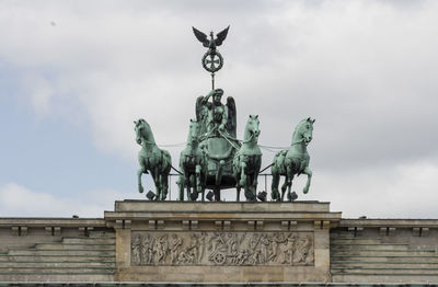 Low angle view of statue against cloudy sky