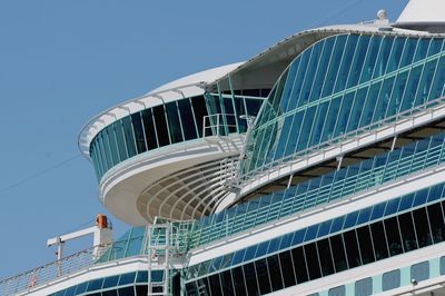 Low angle view of modern building against clear blue sky