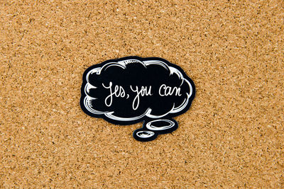 High angle view of text on heart shape on sand