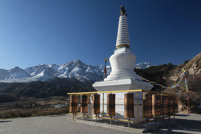 Building against blue sky with mountain in background