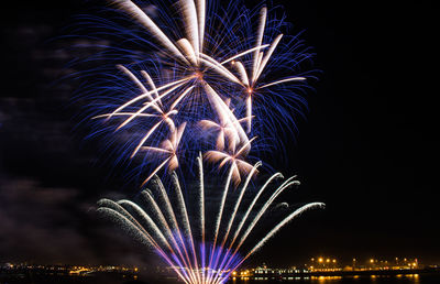 Low angle view of firework display at night