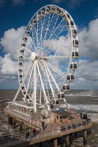 Low angle view of ferris wheel against sky