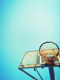 Low angle view of basketball hoop against clear blue sky