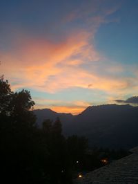 Scenic view of silhouette mountains against sky at sunset