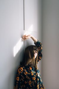 Woman standing against wall