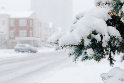 Snow covered car in city