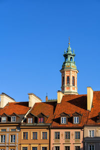 Low angle view of buildings against blue sky