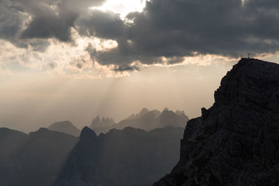 Scenic view of silhouette mountains against sky at sunset