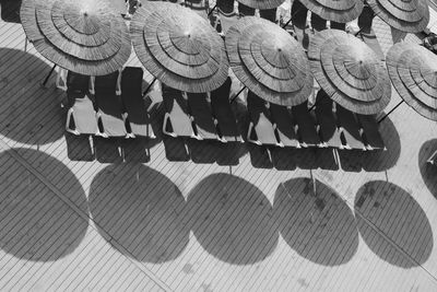 High angle view of sun loungers with canopies in row