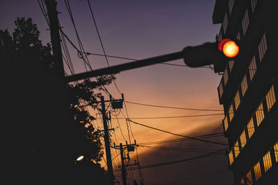 Low angle view of illuminated street light against sky during sunset