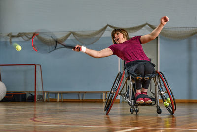 Rear view of woman exercising in gym