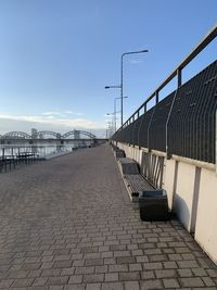 View of empty street against blue sky