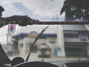 Blurred motion of man seen through wet window