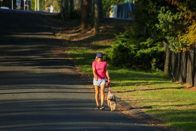 Woman with dog walking in park