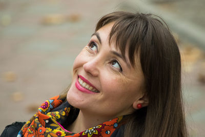 Smiling mid adult woman looking away at park during autumn