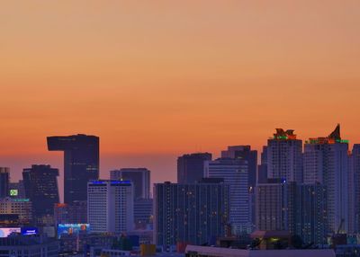 Modern buildings against romantic sky at sunset