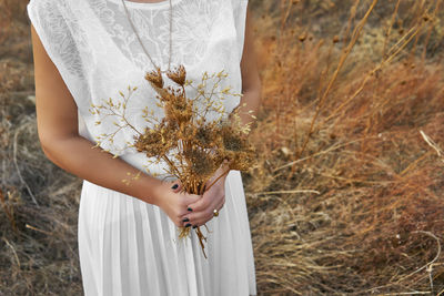 Close-up of woman holding flower