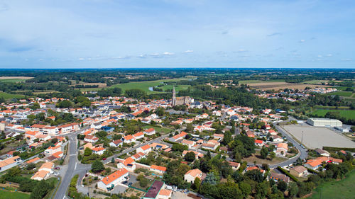 High angle view of town by sea against sky