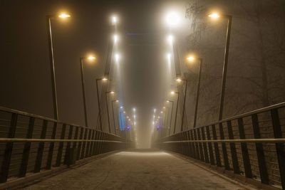 Illuminated street lights on bridge at night