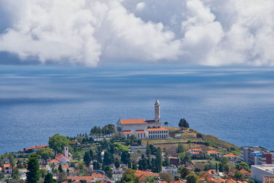 High angle view of buildings against cloudy sky