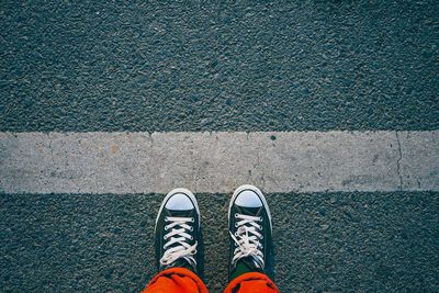 Low section of person standing on road