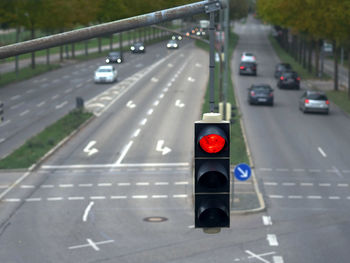 Close-up of traffic light against the road