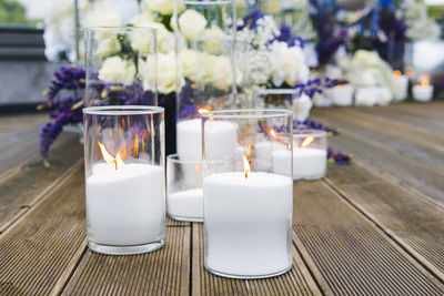 Close-up of illuminated candles on table