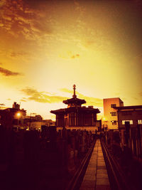 View of illuminated street lights at sunset