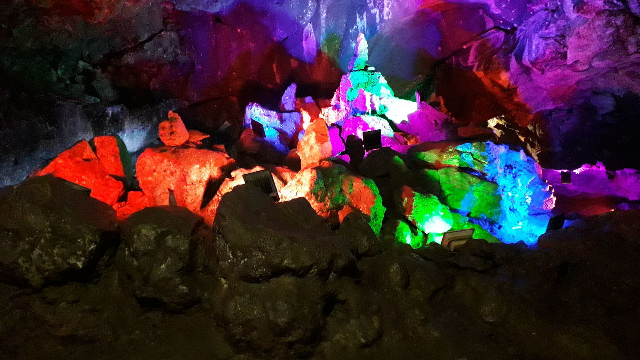 multi colored, no people, night, illuminated, art and craft, nature, rock, cave, indoors, glowing, rock - object, burning, close-up, solid, water, creativity, fire, fire - natural phenomenon